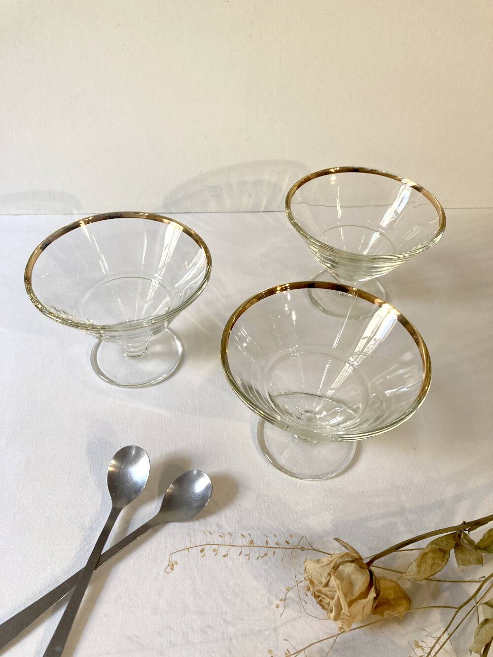 Trio of glass dessert bowls with gold rims, La Rochère, France