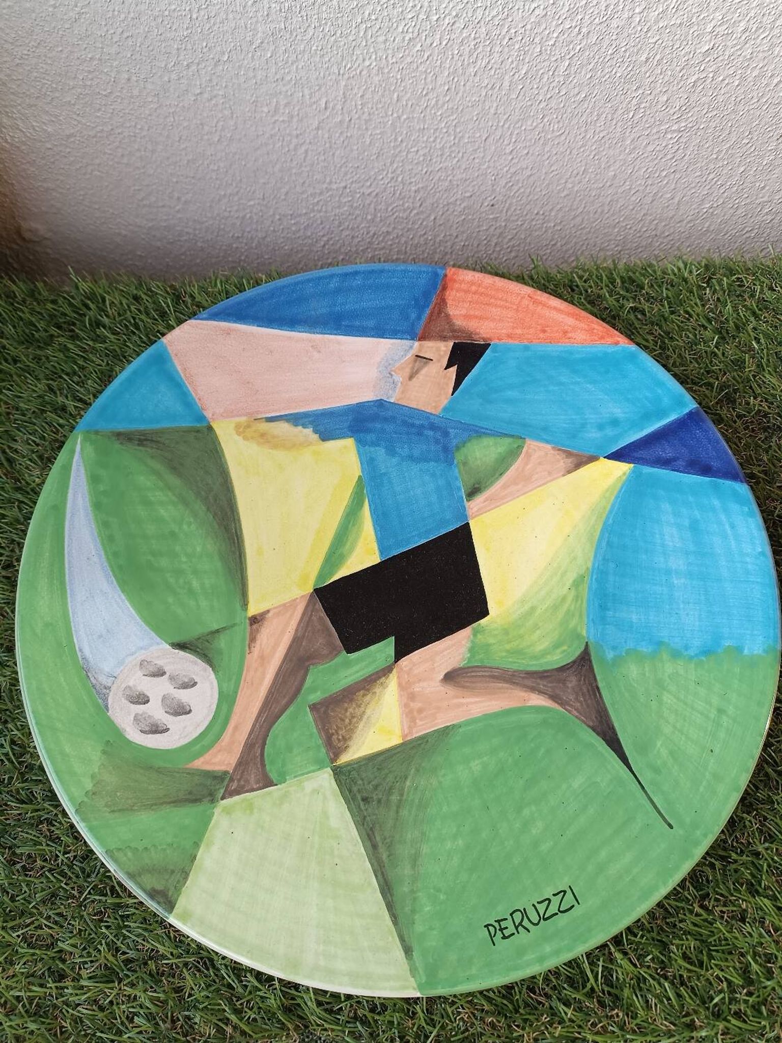 Osvaldo Perruzzi designer of polychrome faience plates.