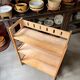 Folding bookshelf in light wood.