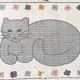 1980s handwoven cotton rug with a cat and flower pattern