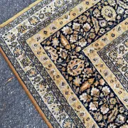 Large Persian wool rug 250x350 cm in gold and navy blue.