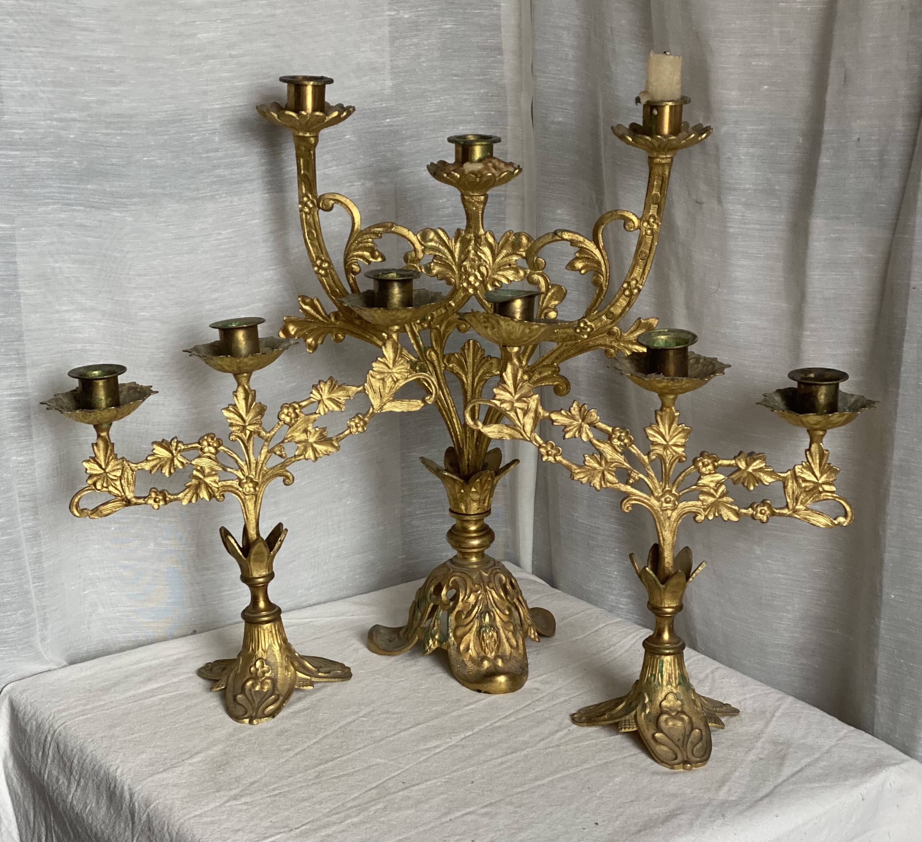 Set of 3 gilt metal candlesticks from the early 20th century.