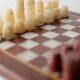 Vintage marble chess set from the 1960s, cream, burgundy and gold board with metal inlay, stone pieces.