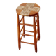 Antique wooden bar stool with a straw seat