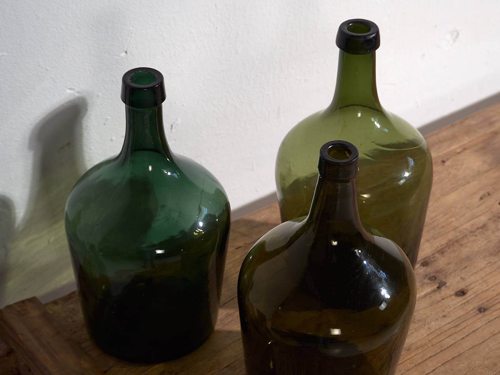 Antique green demijohns (circa 1920). Set of 3 pieces