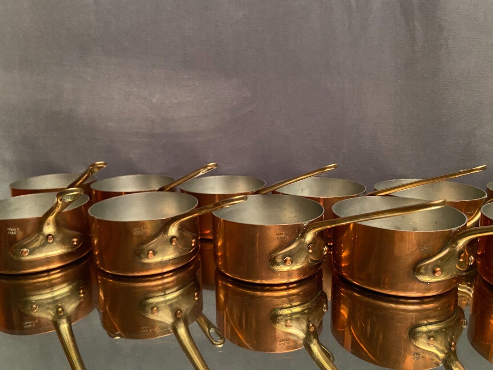 Suite of 12 tinned copper pans