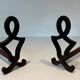 Pair of Modernist Andirons in Cast Iron with Stylised Figure Supports, by Ray