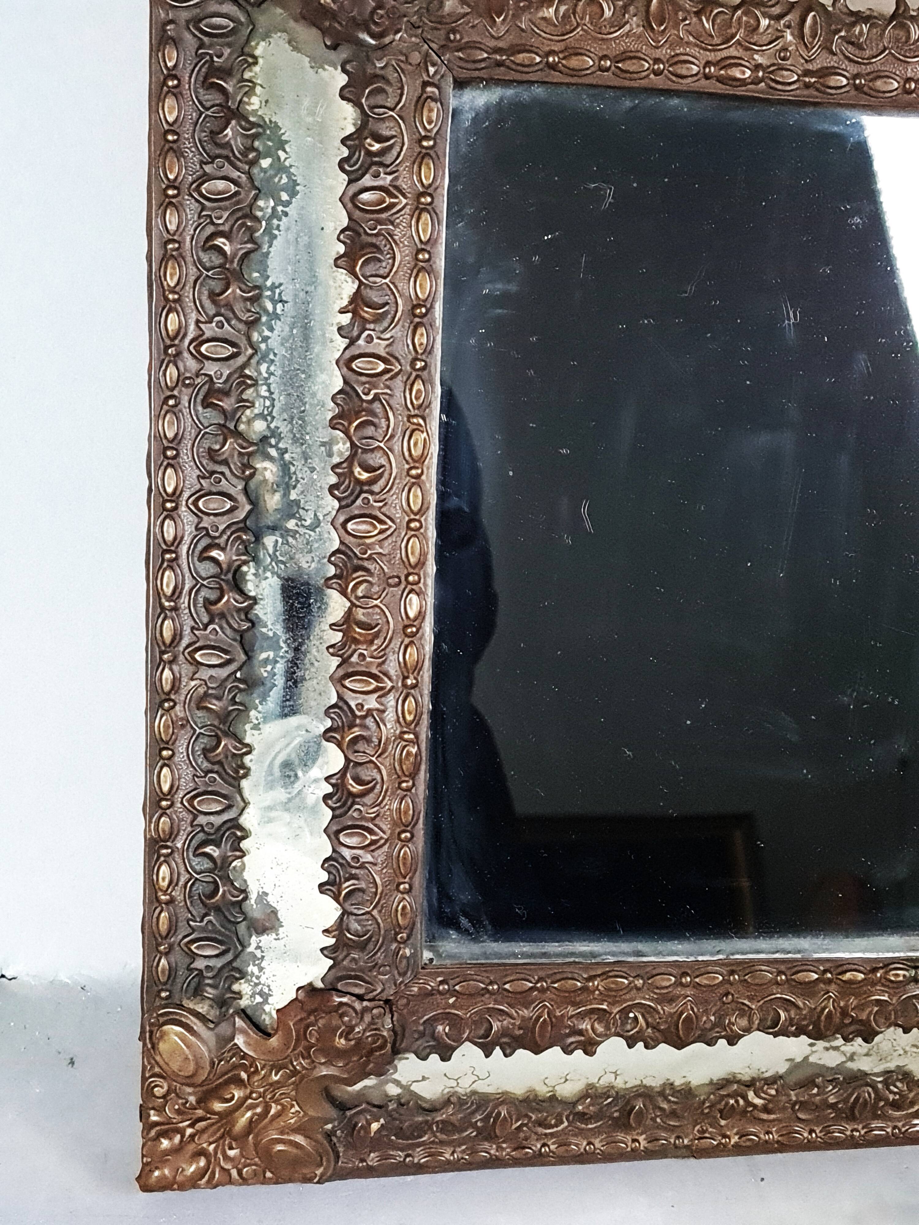 Antique brass repoussé mirror with wooden backing, 59x31 cm, C831.