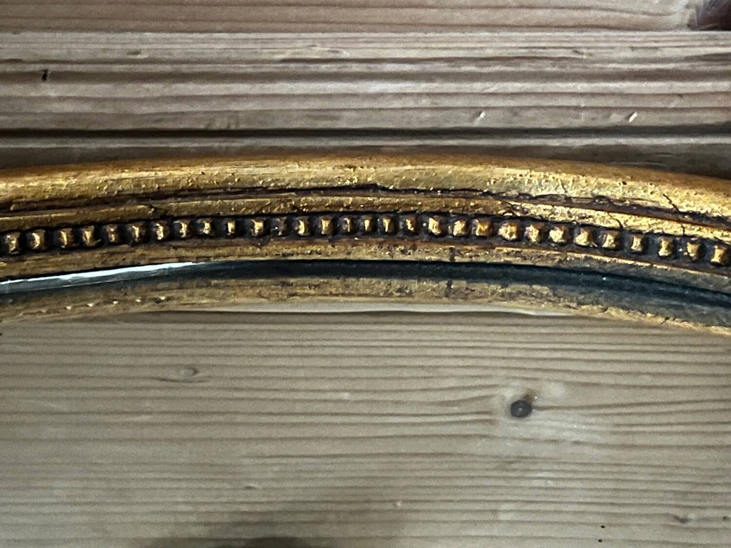 Old oval gilded stucco mirror