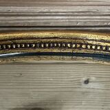 Old oval gilded stucco mirror
