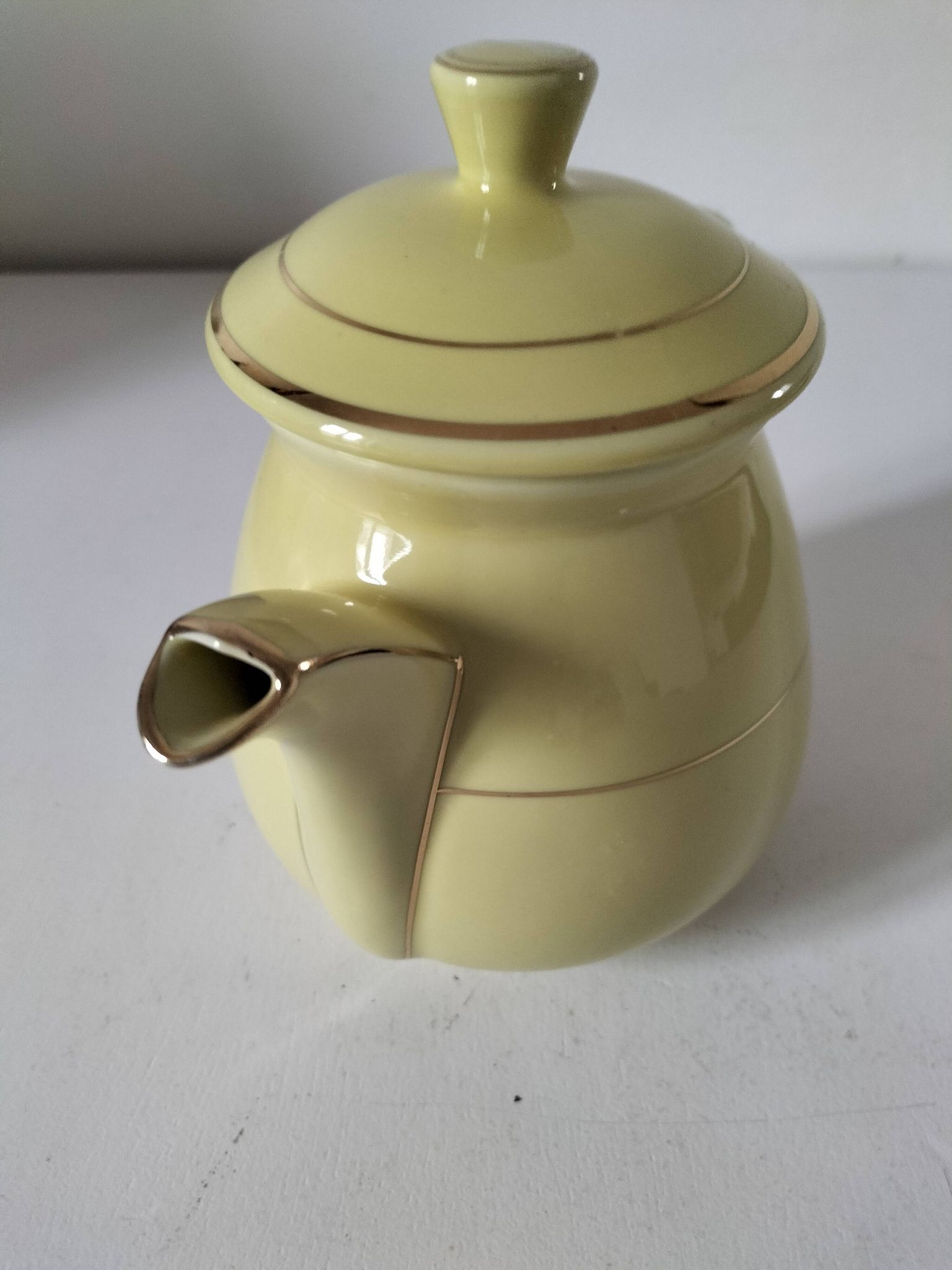 Vintage teapot in pastel yellow earthenware with gold trim