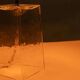 Minimalist glass table lamp from the 80s with a pleated shade.