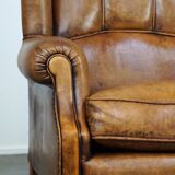 Sheepskin wingback chair with a unique design and a beautiful patina