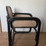 Black armchair with cane and natural rattan