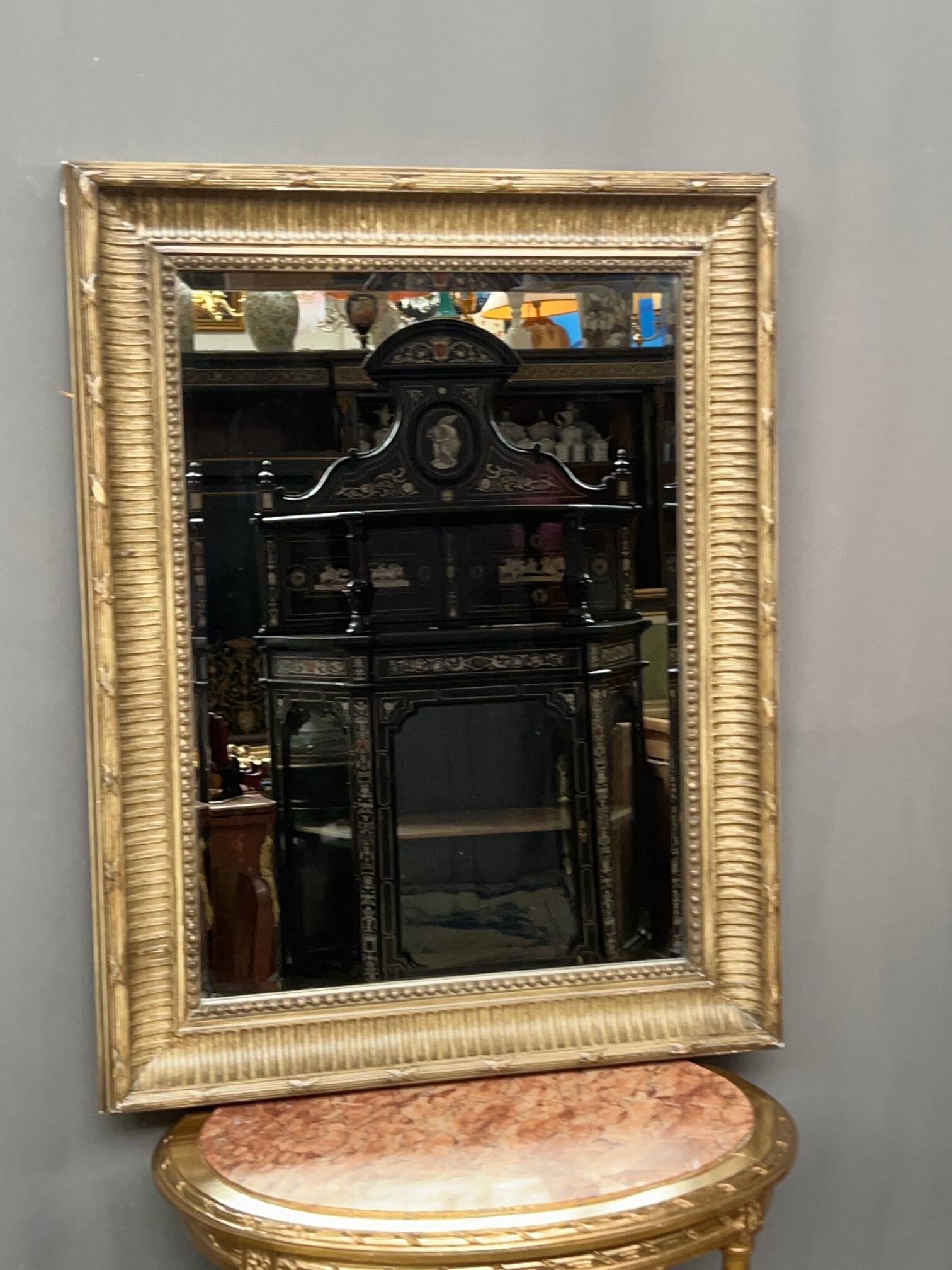 Mirror in a frame with a moulding.