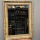 Mirror in a frame with a moulding.