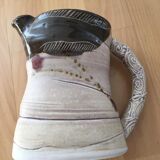 Signed ceramic pitcher. Glazed part. Worked cove