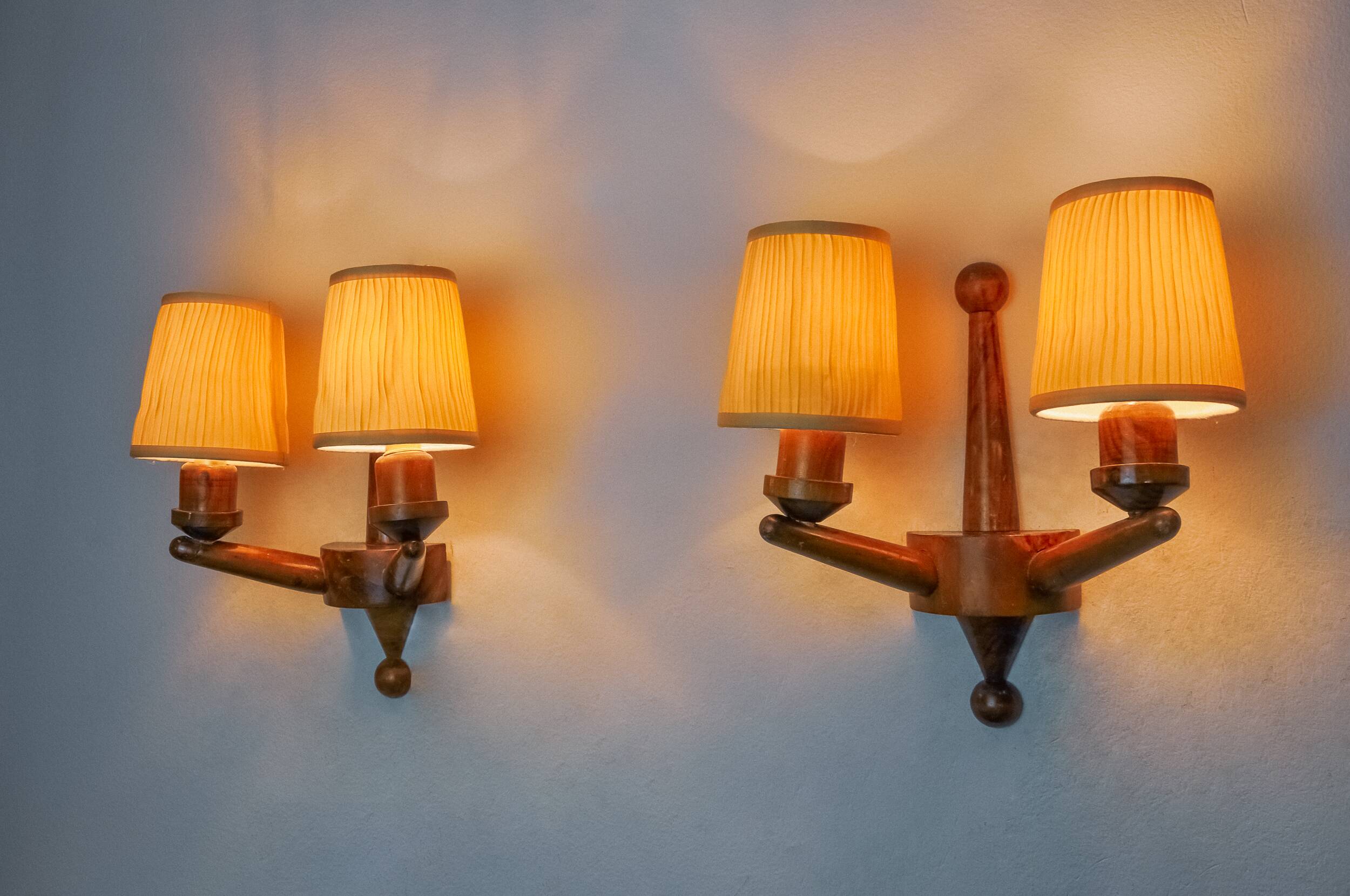 Pair of two-armed art deco wall lights, carved wood, France, 1960