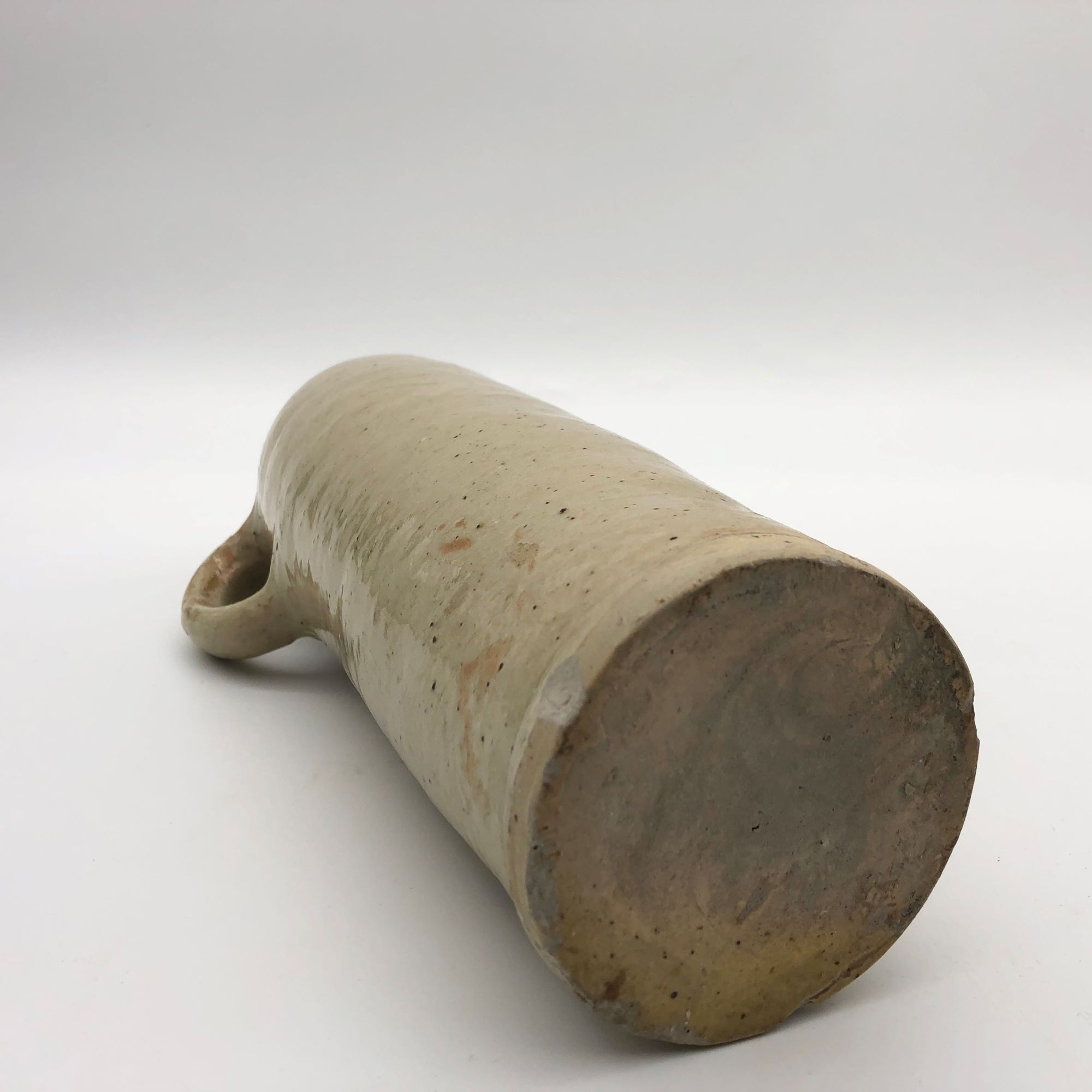 Old hot water bottle in glazed stoneware, beige color