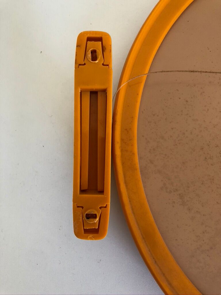 Tiltable orange plastic mirror with matching wall light