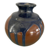 Old blue and brown vase with drips.