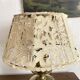 Antique brass lamp with embroidered openwork shade.