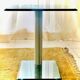 Contemporary square side table in glass with a metallic central column.