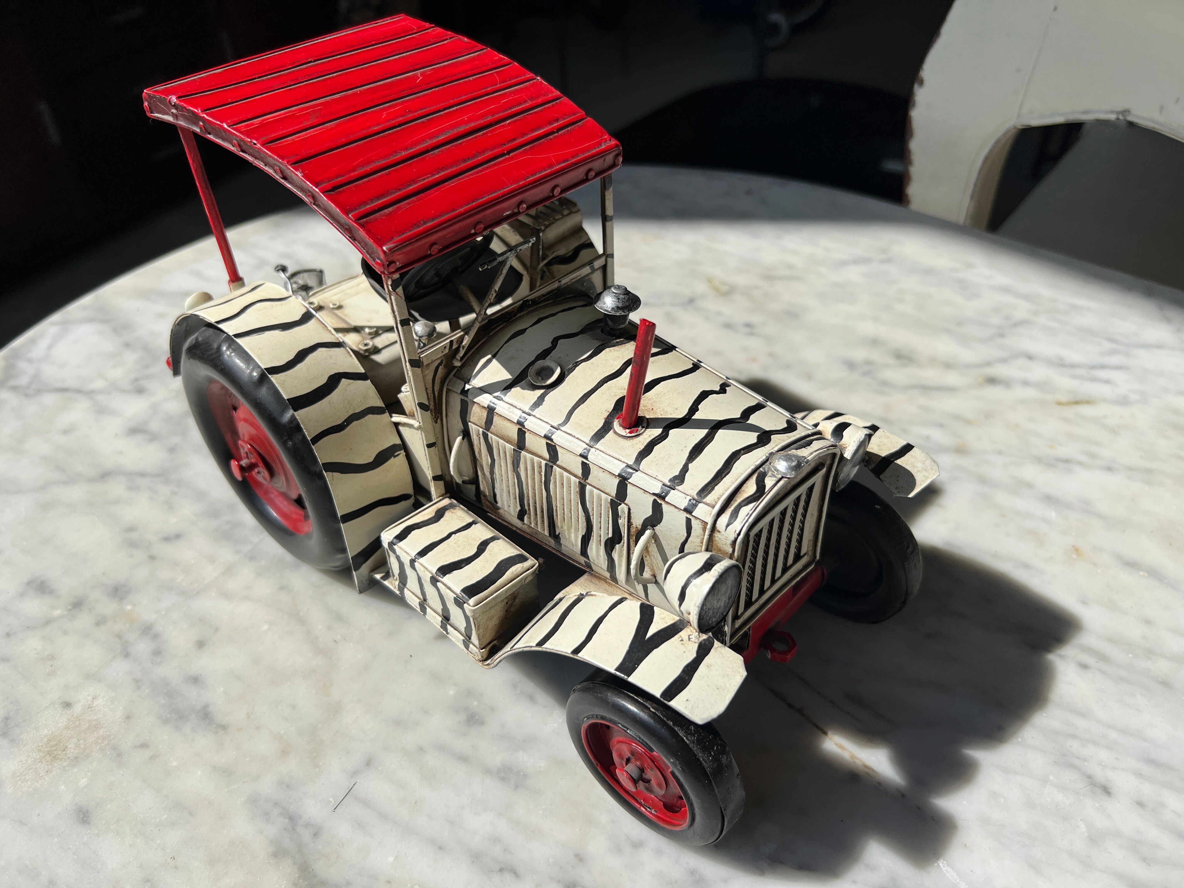 Old zebra metal tractor