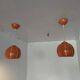Paire de globes 70's en métal laqué orange.