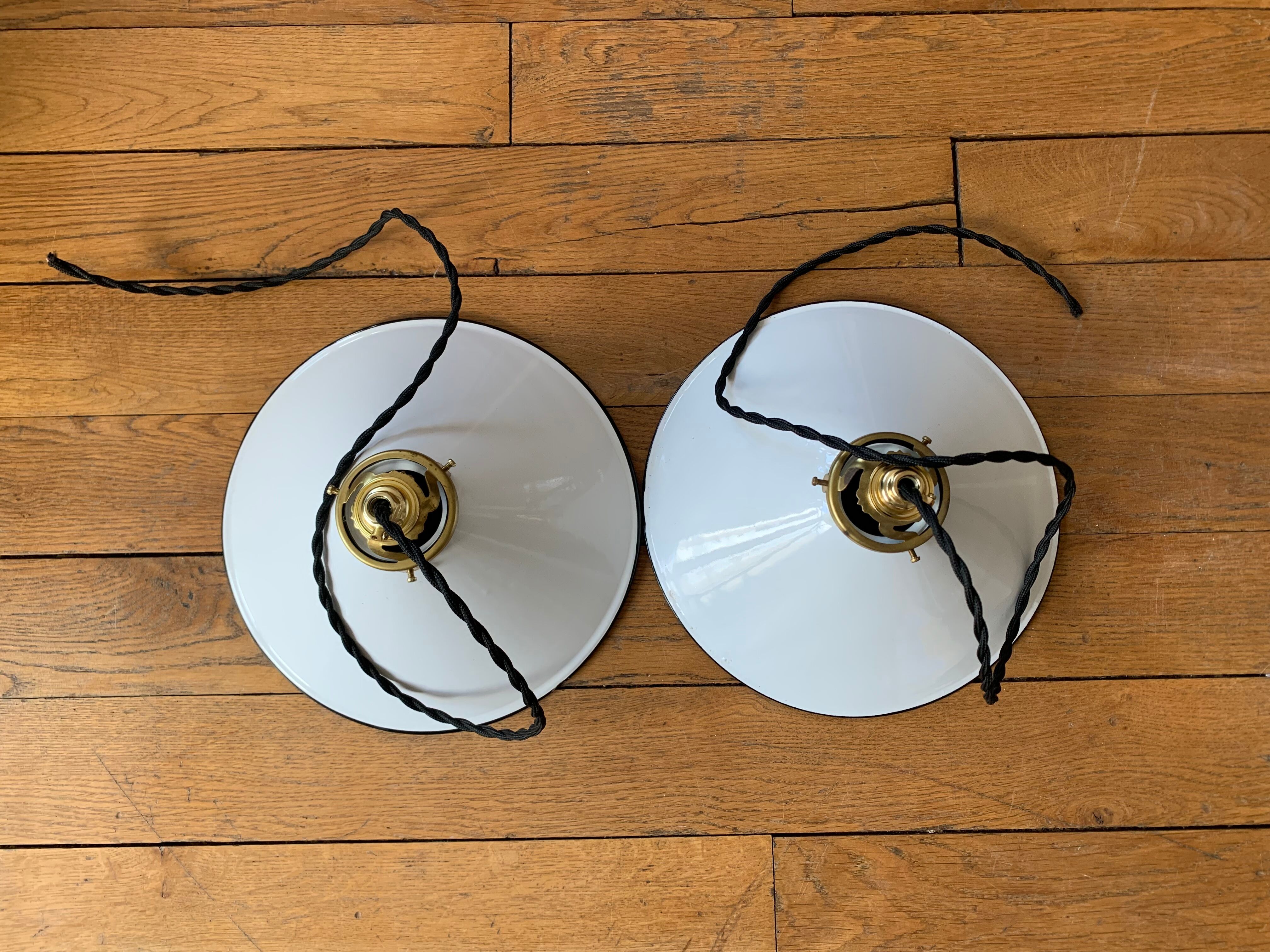 Old pair of white industrial metal suspensions with black border