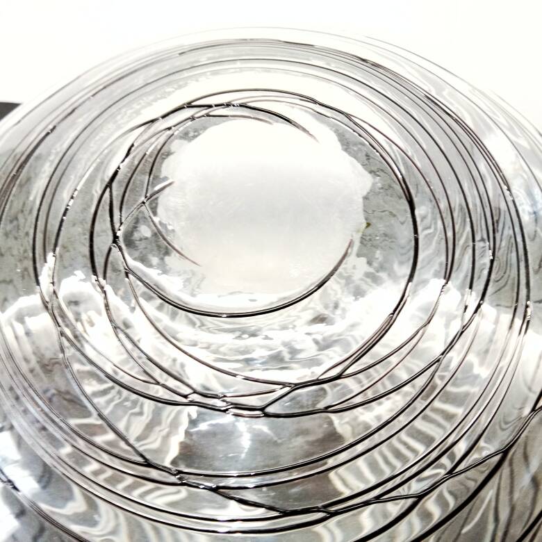 Textured oval blown glass vase with black and white glass spaghetti.