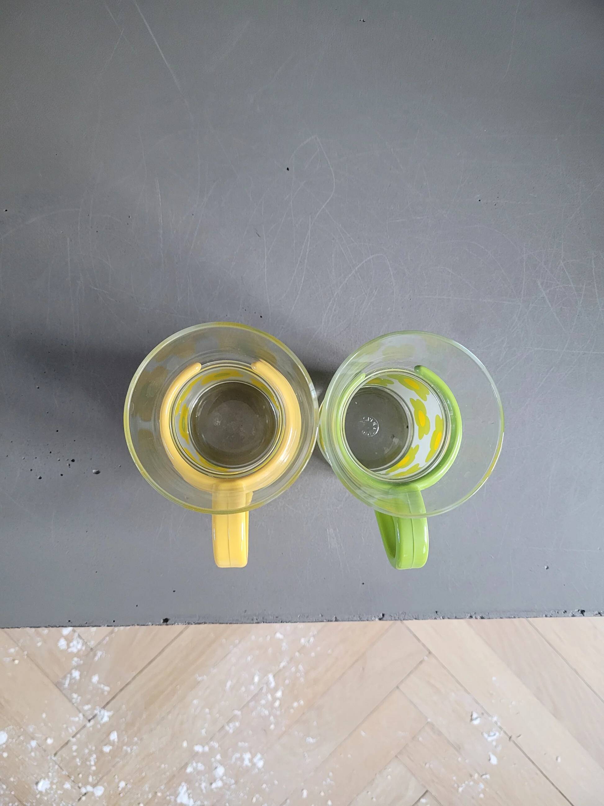Pair of glass teacups with plastic handles