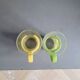Pair of glass teacups with plastic handles