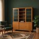 Vintage wooden display cabinet with green glass.