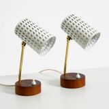 A pair of mid-century modern bedside lamps with perforated metal shades