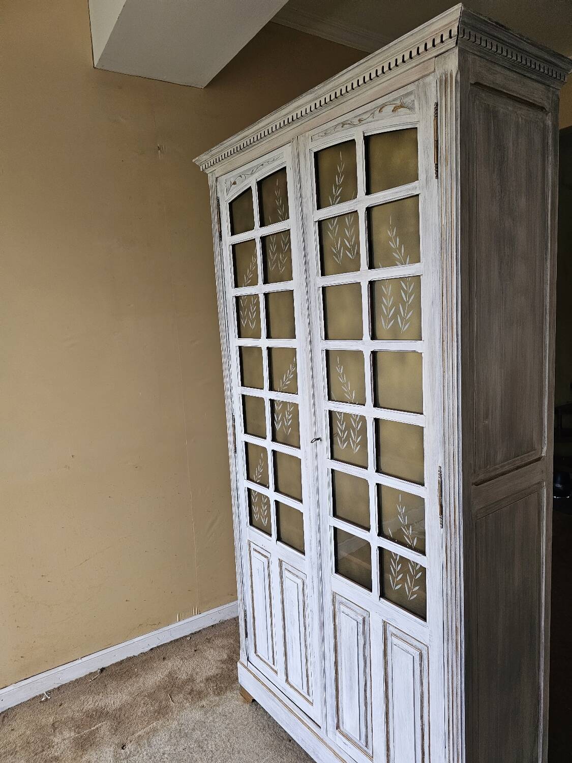 Antique bookcase with a white cerused patina