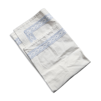 Vintage embroidered pillowcase with light blue thread.