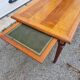 English wood coffee table with leather shelves