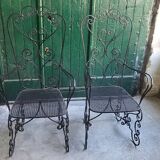 Pair of black wrought iron armchairs