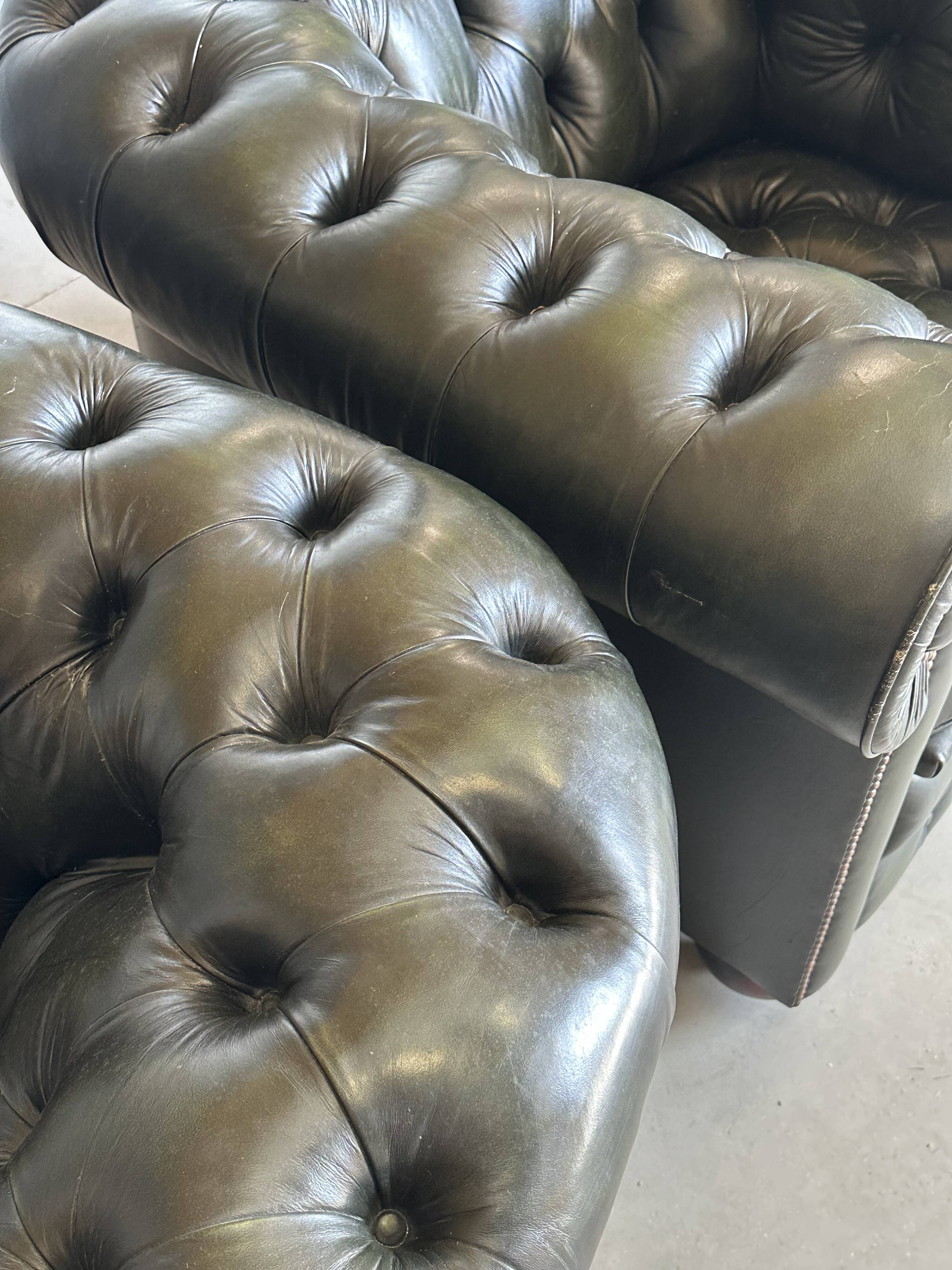 Title: Pair of vintage olive green leather Chesterfield armchairs