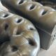 Title: Pair of vintage olive green leather Chesterfield armchairs