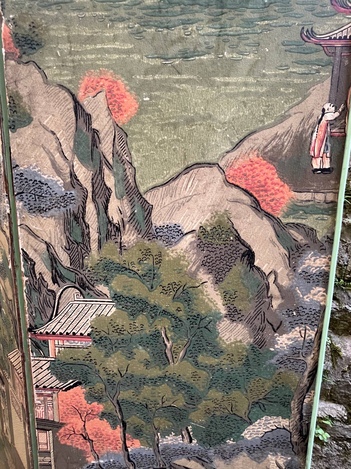 Wooden screen in Asian style, covered with Chinese wallpaper.