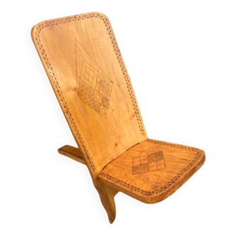 Large vintage African chair in solid wood carved with geometric patterns