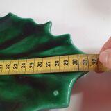empty green ceramic pocket cup, small chips on the edges, signed