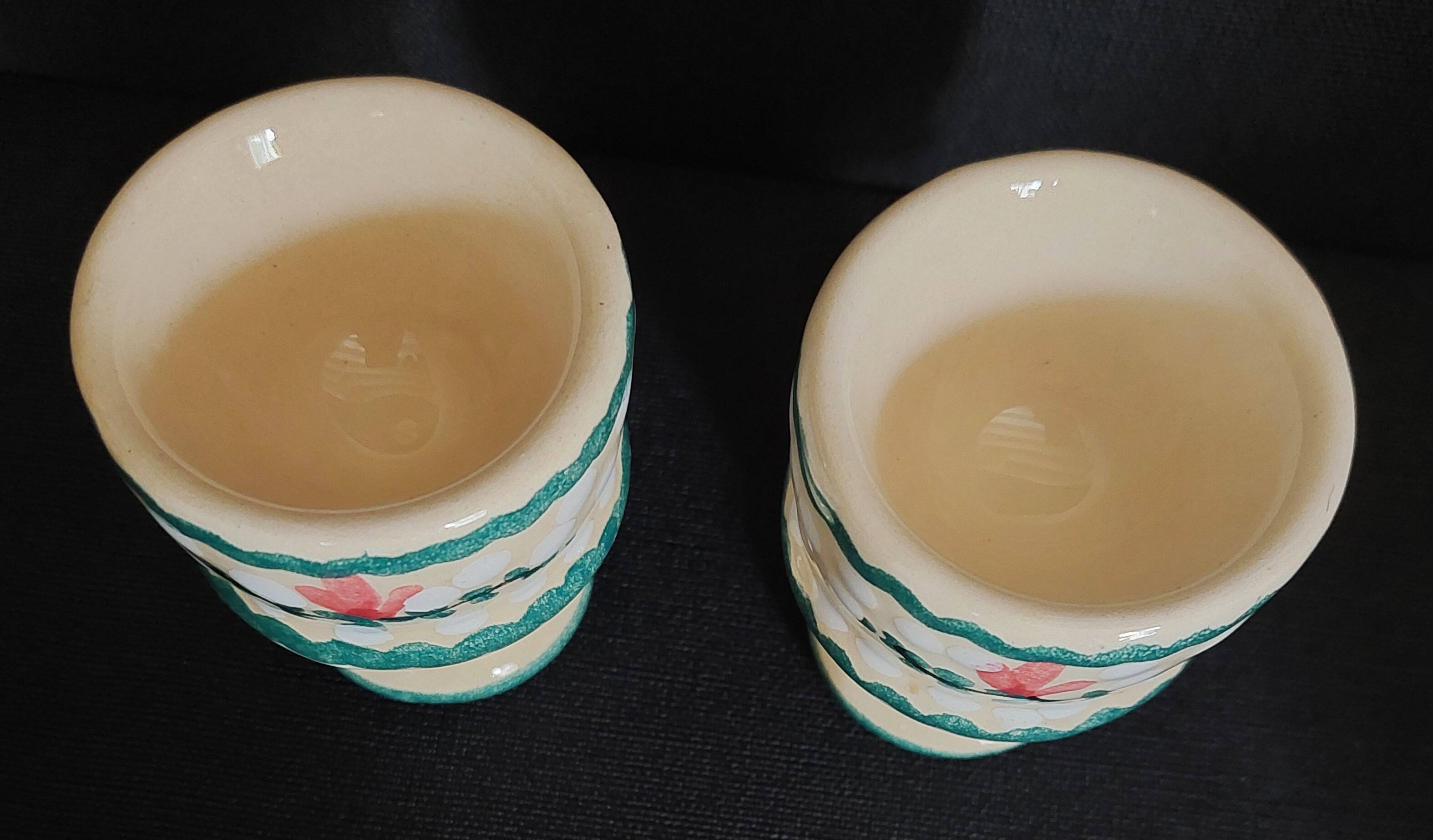 Pair of vintage earthenware egg cups with hand-painted decoration
