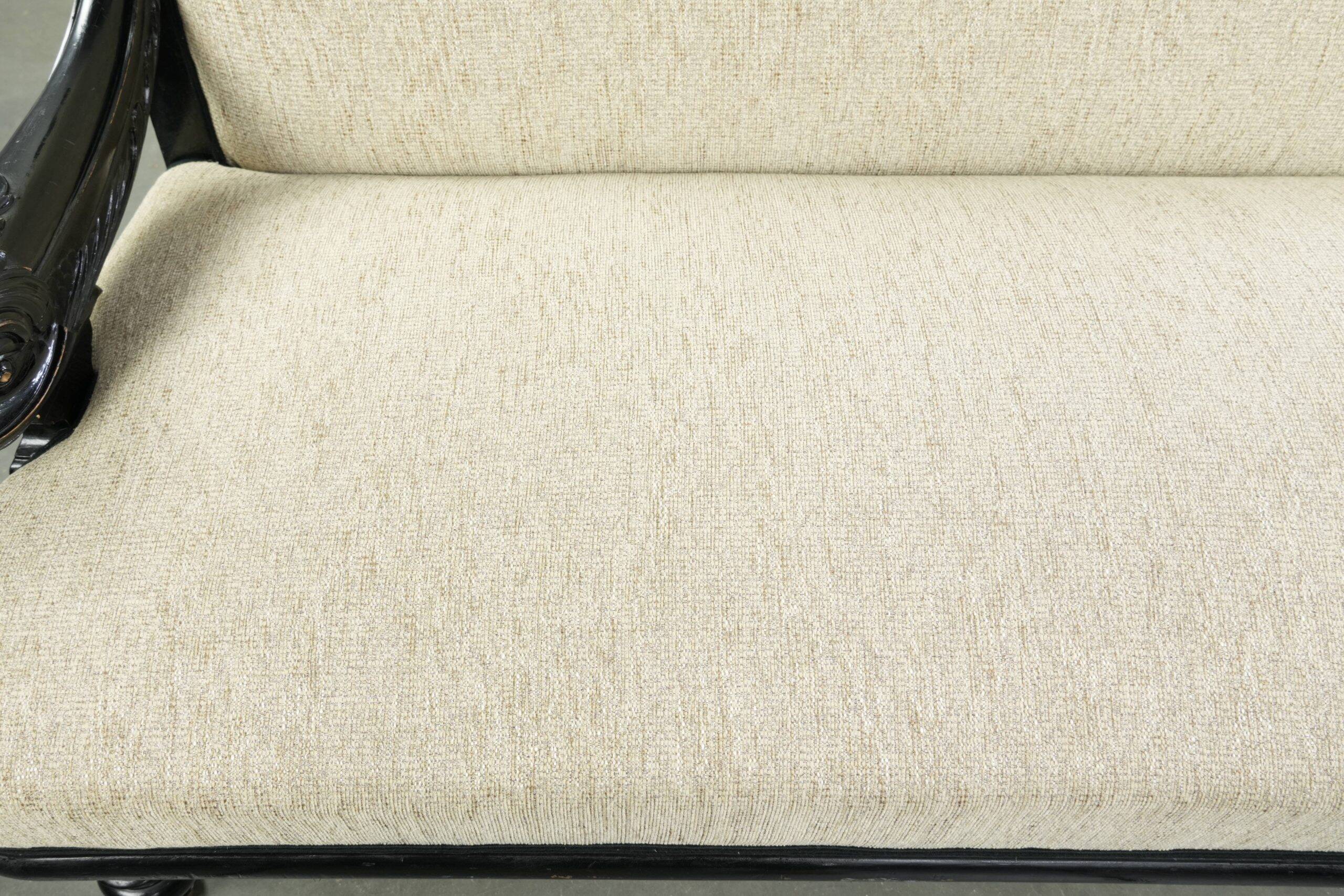 French sofa from the 19th century in Empire style with detailed armrests