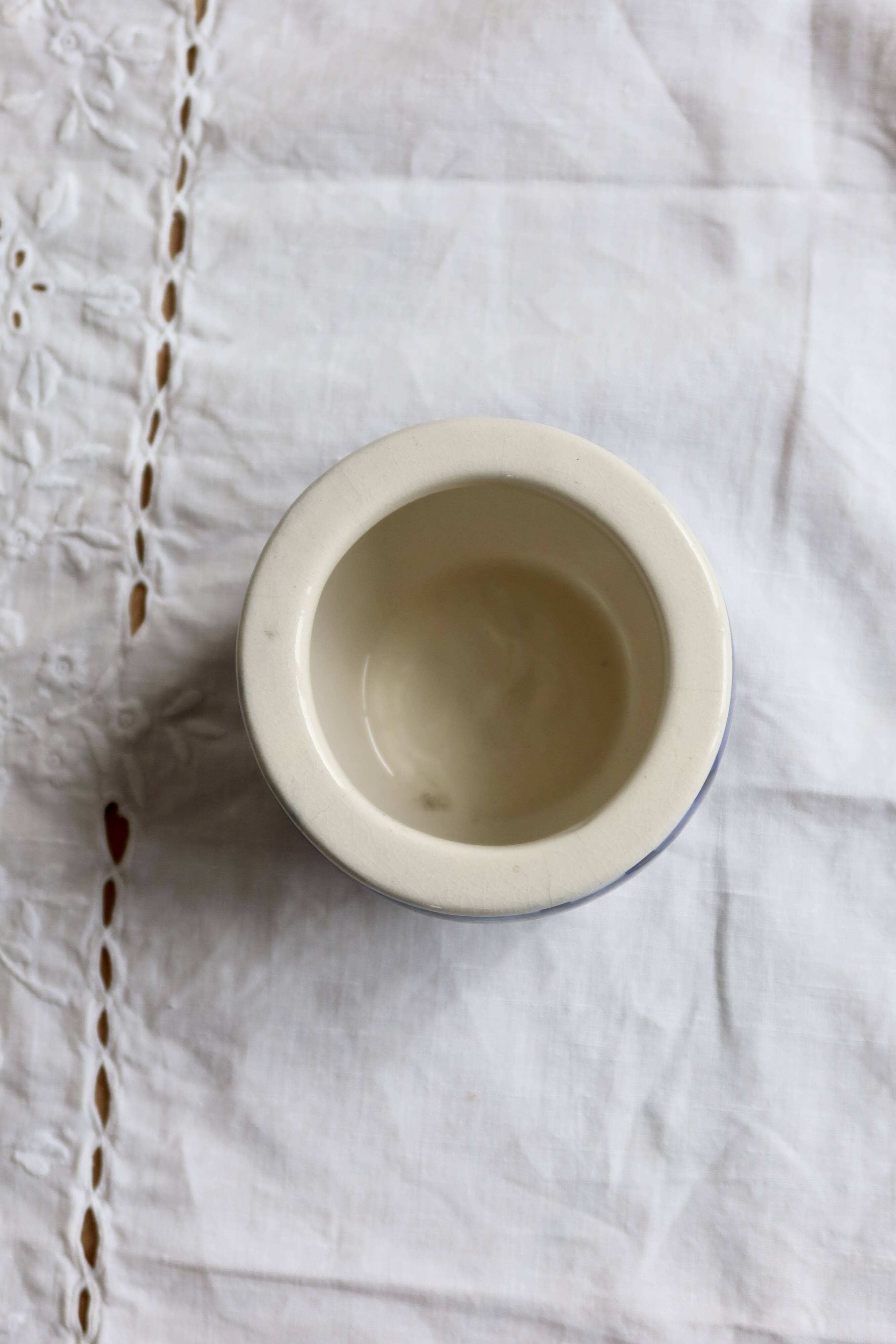 Vintage ceramic cache-pot with navy blue gingham pattern.