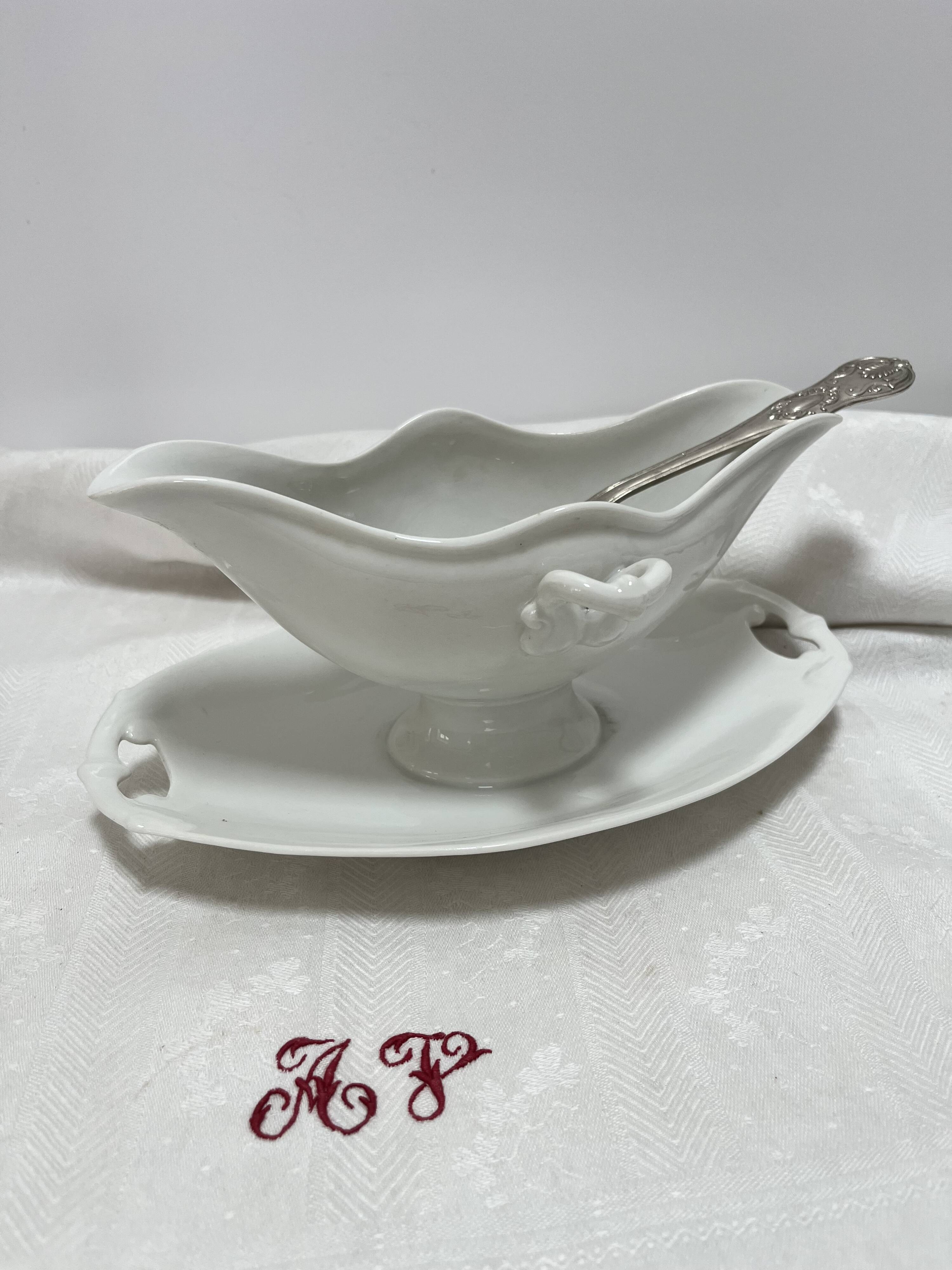 White porcelain sauce boat on tray