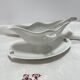 White porcelain sauce boat on tray