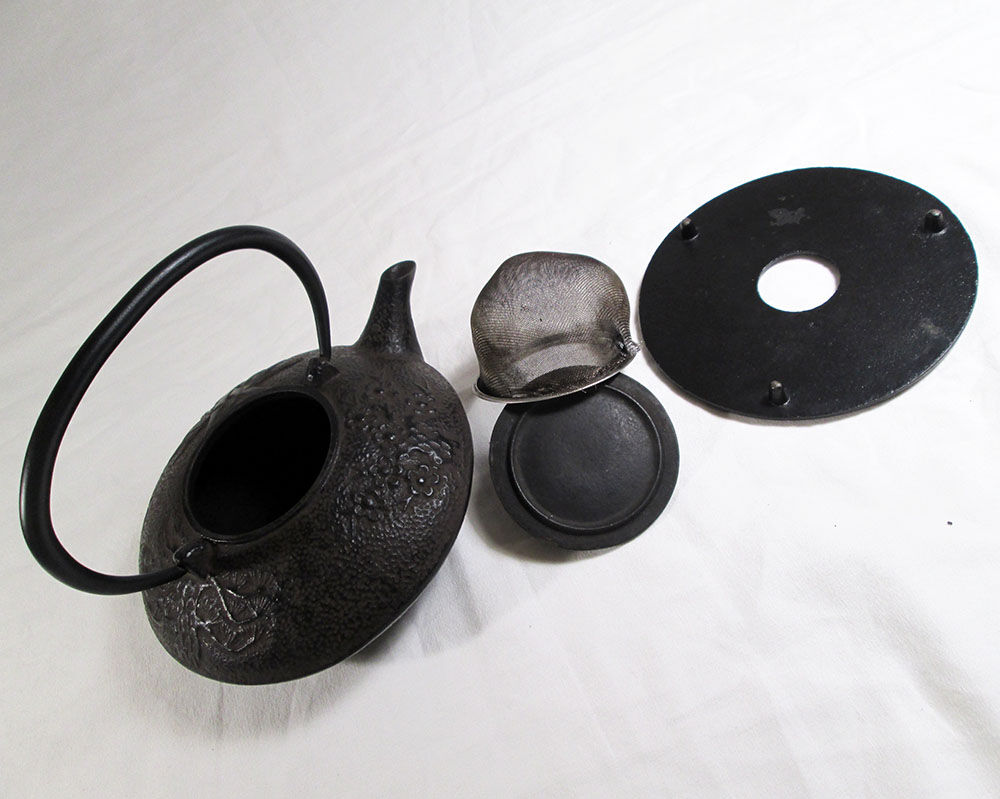 Antique cast iron teapot decorated